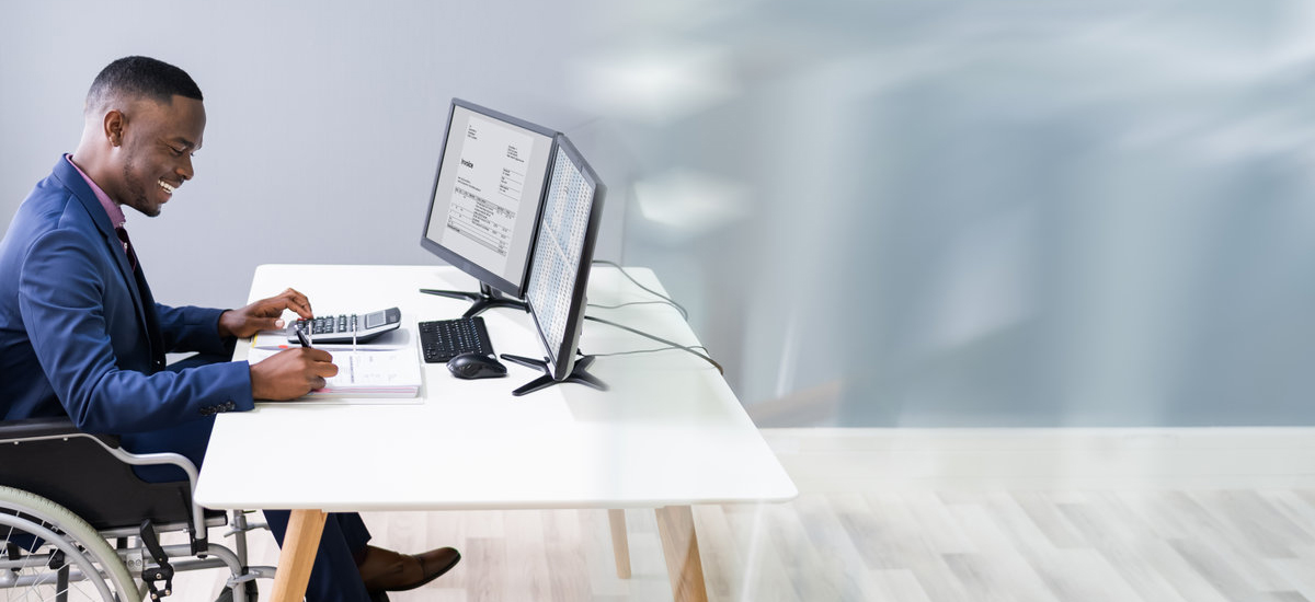 Man in wheelchair at desk