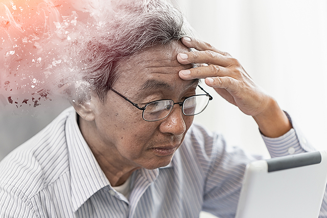 Image of older male holding head with graphic art