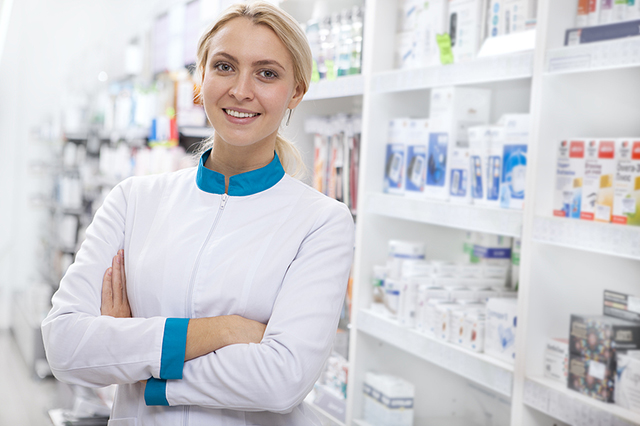 Pharmacist smiling in pharmacy