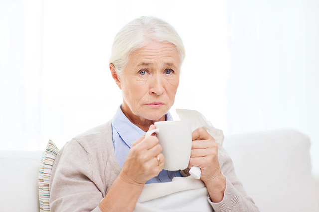 older lady with hot drink